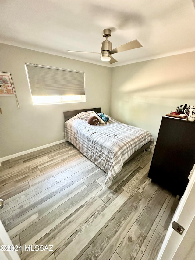 bedroom with ceiling fan and hardwood / wood-style flooring