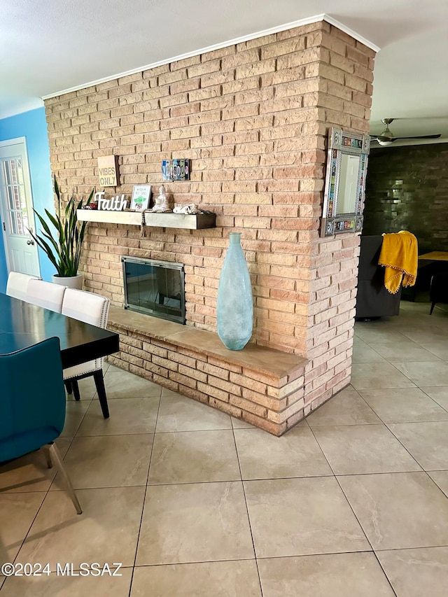 tiled living room with a brick fireplace