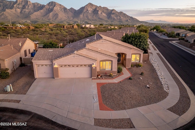 view of front of property featuring a mountain view and a garage