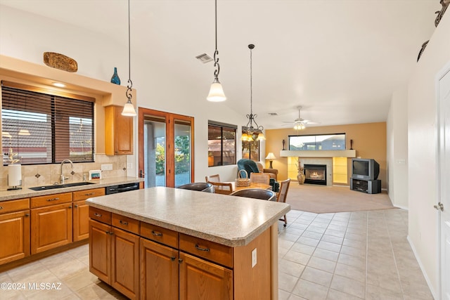 kitchen with sink, a kitchen island, pendant lighting, and lofted ceiling