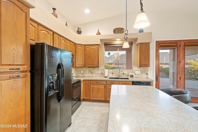 kitchen with sink, decorative light fixtures, a wealth of natural light, and black appliances