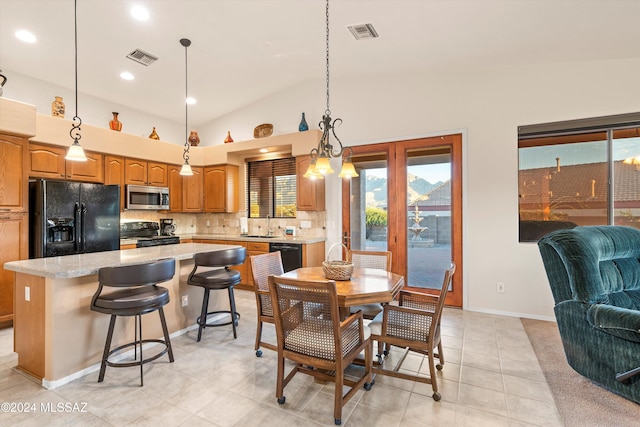 tiled dining area featuring an inviting chandelier, vaulted ceiling, and sink