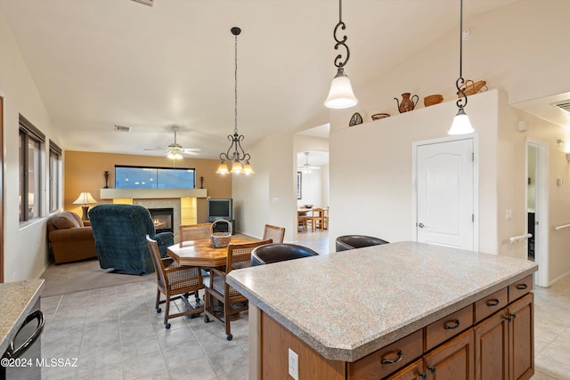 kitchen featuring a center island, hanging light fixtures, lofted ceiling, and light tile patterned flooring