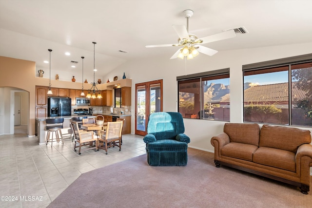 living room with ceiling fan, light tile patterned flooring, and lofted ceiling