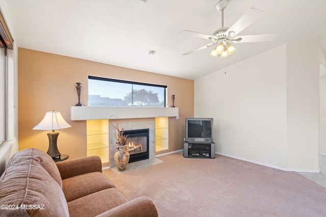 carpeted living room with a fireplace and ceiling fan