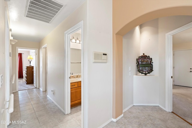 hall featuring light tile patterned floors