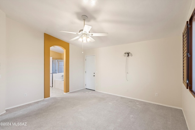 unfurnished room with ceiling fan and light carpet