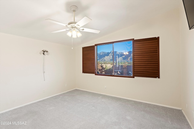 carpeted empty room featuring ceiling fan and lofted ceiling