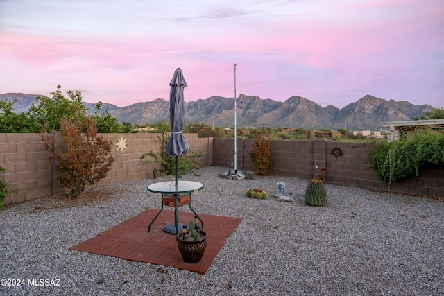 exterior space with a mountain view and a patio