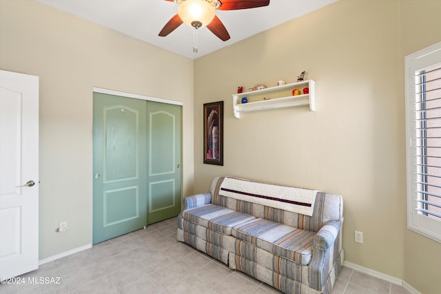 living area featuring ceiling fan and light tile patterned flooring