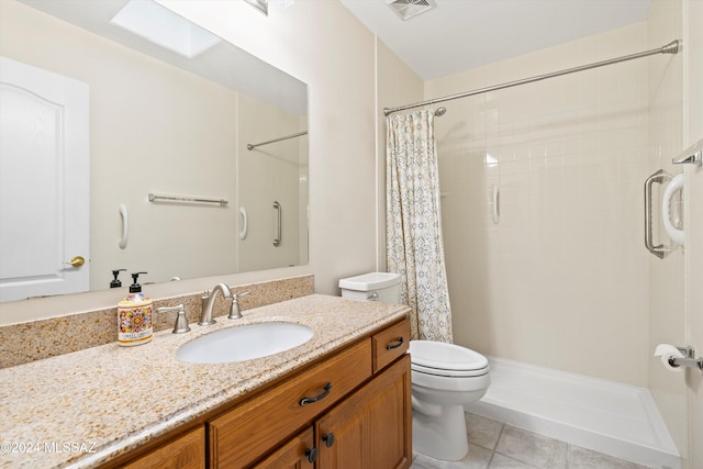 bathroom featuring tile patterned flooring, vanity, toilet, and curtained shower