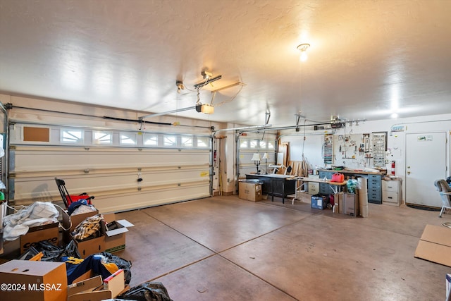 garage with a workshop area and a garage door opener