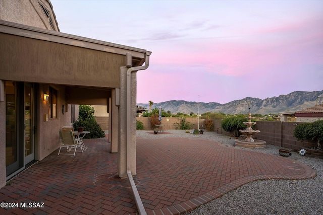 patio terrace at dusk with a mountain view