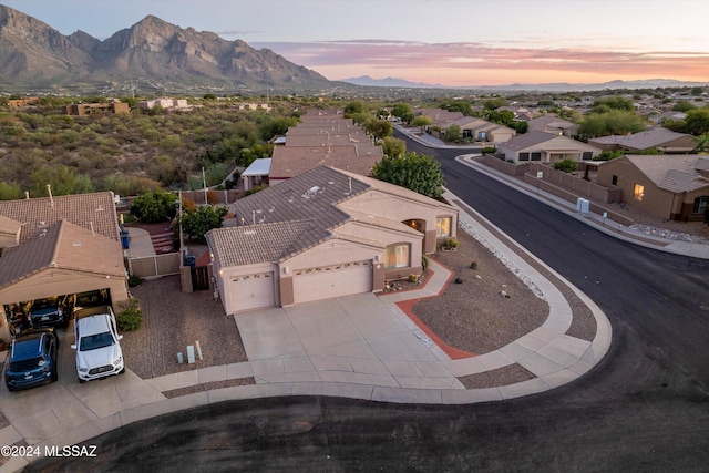 aerial view at dusk featuring a mountain view