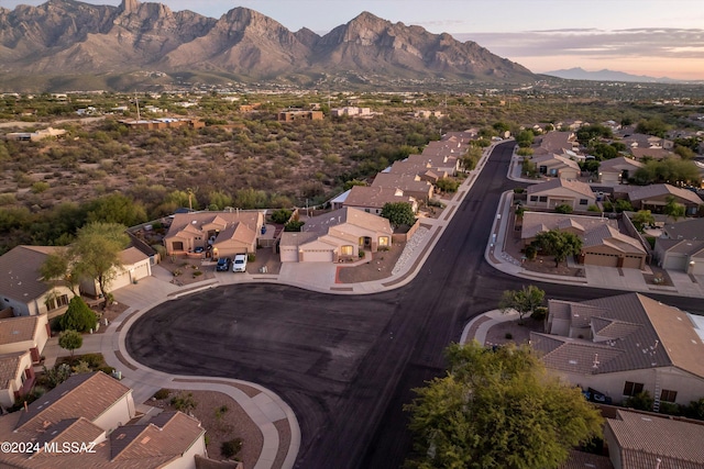 aerial view at dusk featuring a mountain view