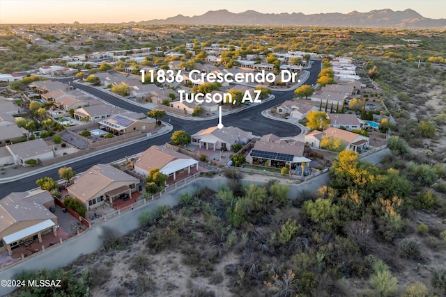 aerial view at dusk featuring a mountain view