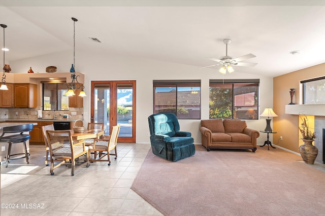 tiled living room with ceiling fan, lofted ceiling, and sink