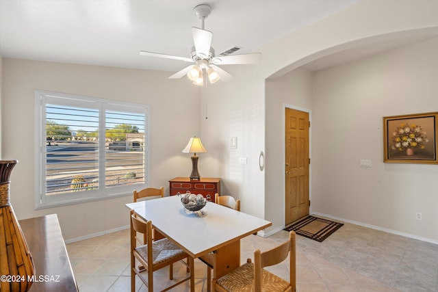 dining room featuring ceiling fan, light tile patterned floors, and lofted ceiling