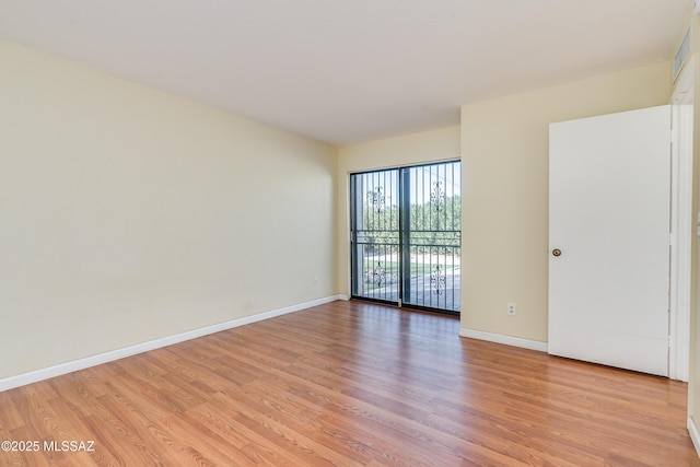 unfurnished room featuring light wood-style flooring and baseboards