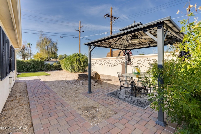 view of patio / terrace featuring a gazebo, outdoor dining area, and fence