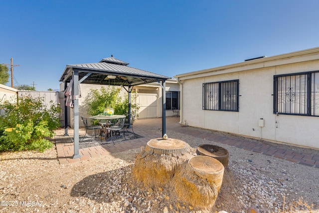 view of patio featuring a gazebo and fence