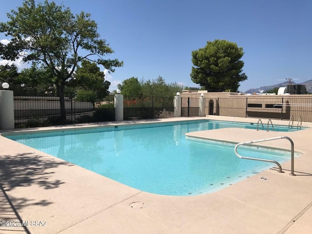 view of pool with a patio area, fence, and a fenced in pool