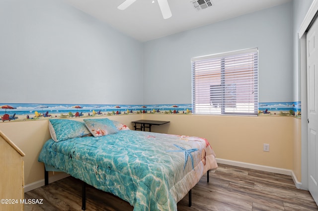 bedroom featuring a closet, hardwood / wood-style flooring, and ceiling fan