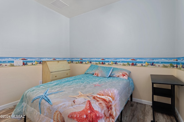 bedroom with hardwood / wood-style flooring and vaulted ceiling