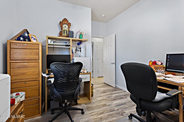 office with light wood-type flooring