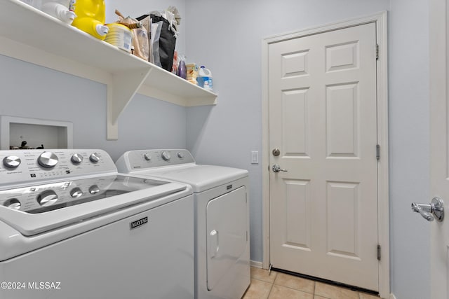 laundry area with light tile patterned floors and independent washer and dryer