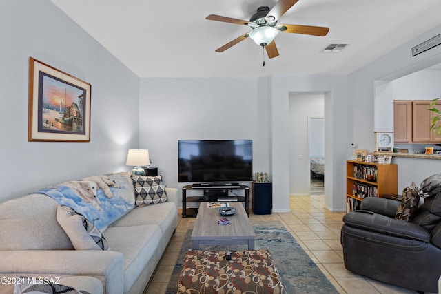 tiled living room featuring ceiling fan