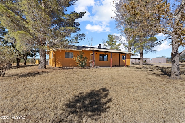 back of house with a yard