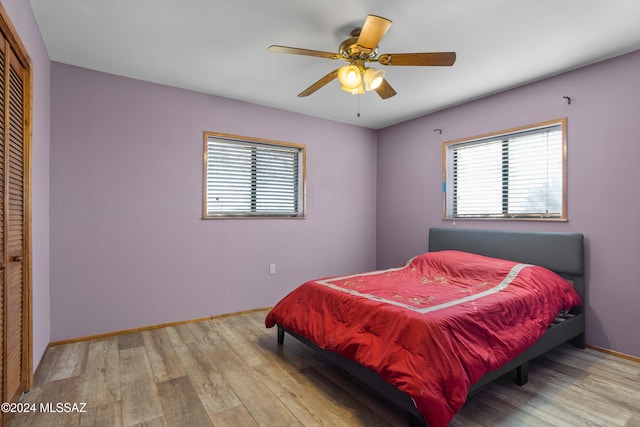 bedroom featuring a closet, ceiling fan, and light hardwood / wood-style floors