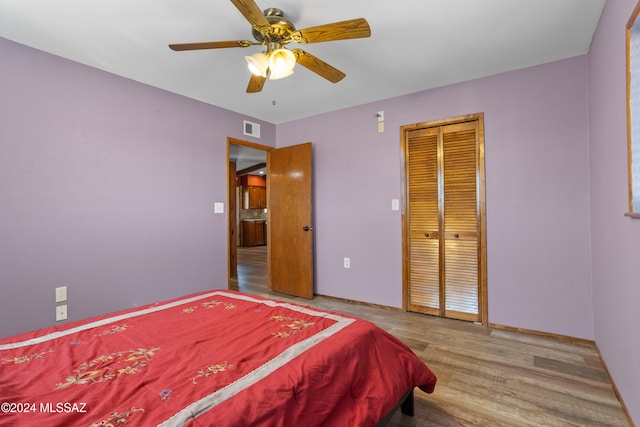 bedroom featuring a closet, ceiling fan, and hardwood / wood-style flooring