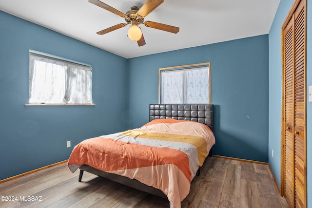 bedroom featuring a closet, hardwood / wood-style floors, and ceiling fan