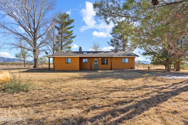 rear view of house featuring a mountain view and a rural view