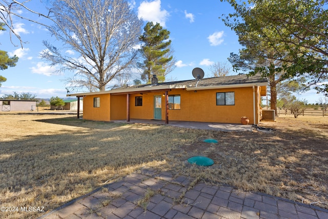 rear view of house with a patio area and a yard