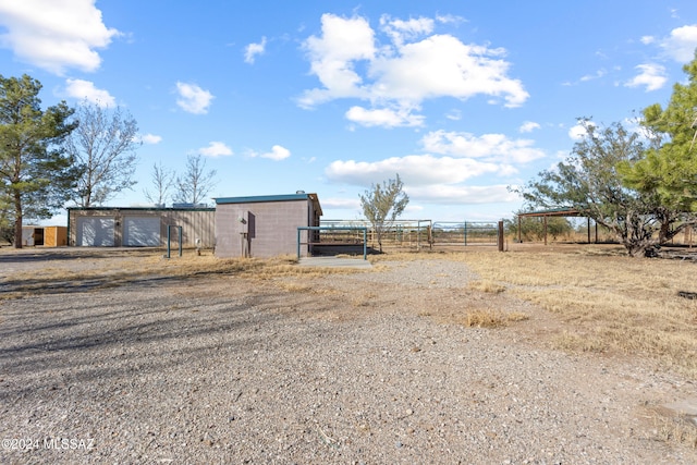 view of yard with an outbuilding and a rural view