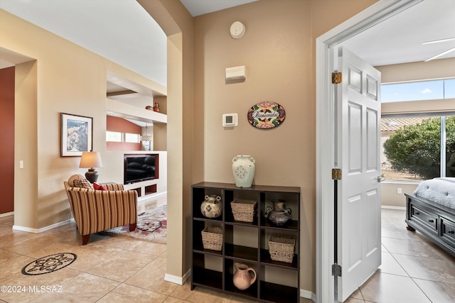 corridor with light tile patterned flooring and built in features