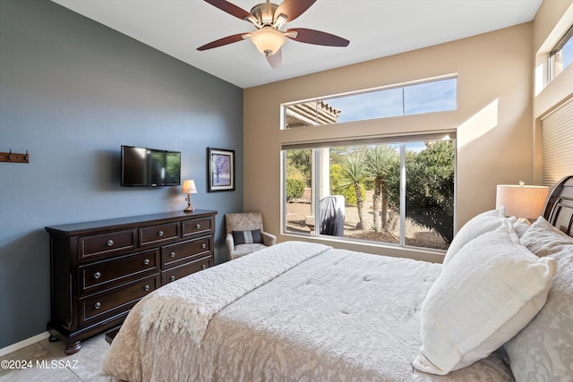 tiled bedroom featuring ceiling fan