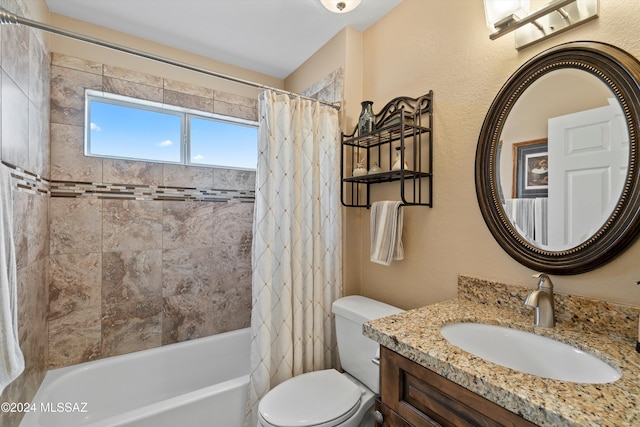 full bathroom featuring vanity, shower / bath combo, and toilet