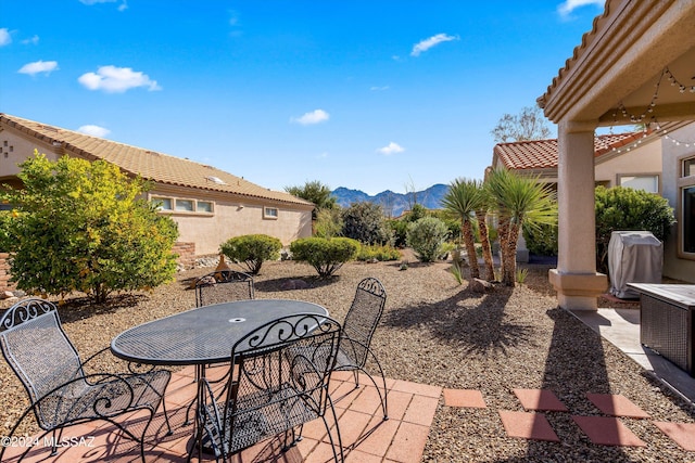 view of patio with area for grilling and a mountain view