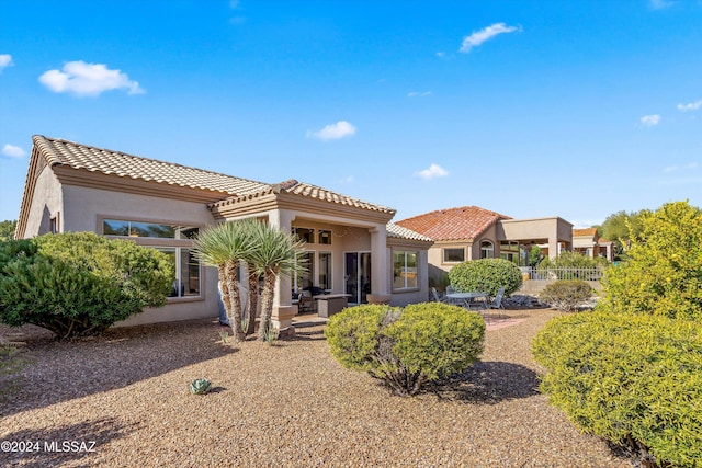 back of property featuring a patio area