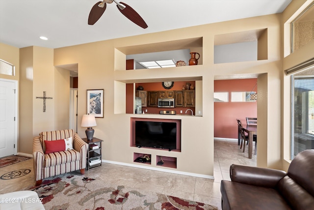 living room featuring light tile patterned floors and ceiling fan