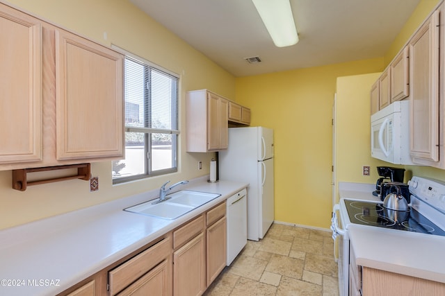 kitchen with sink, white appliances, and light brown cabinets