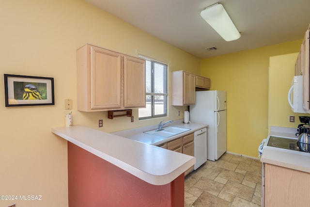 kitchen with kitchen peninsula, sink, white appliances, and light brown cabinets