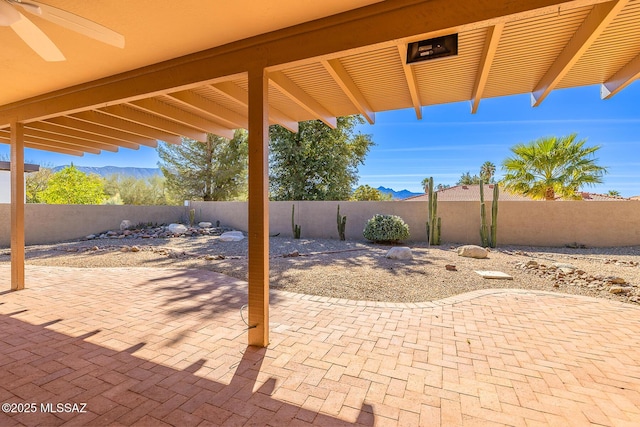 view of patio featuring a fenced backyard and a ceiling fan