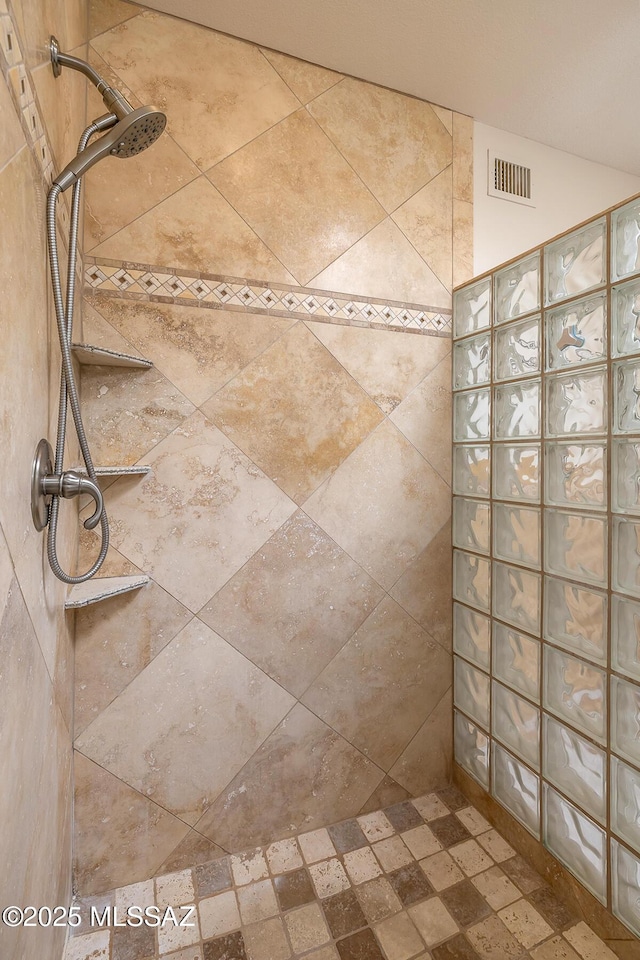 bathroom with visible vents and walk in shower