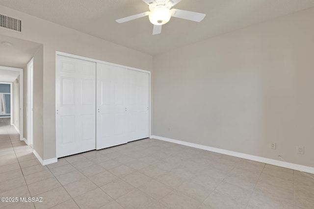 unfurnished bedroom with a ceiling fan, a closet, visible vents, and baseboards