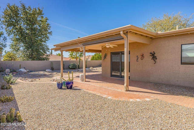 exterior space featuring a patio, a fenced backyard, and a ceiling fan